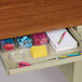 A Hirsh Industries left corner pedestal desk with a drawer filled with stationery and pens.