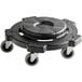 A black plastic dolly with wheels attached to a brown circular trash can lid.