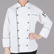 A woman wearing a Mercer Renaissance chef coat.