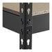 A black metal Hirsh boltless shelving unit with metal particleboard shelves and metal rectangular holes.