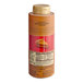 A bottle of Torani Puremade Pumpkin Pie Flavoring Sauce on a counter with a label.