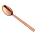 An American Metalcraft hammered bronze spoon with a wooden handle.