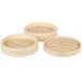 A group of round wooden Town bamboo steamer trays with handles.