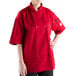 a woman wearing a red chef coat