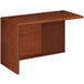 A brown HON 10700 Series "L" Left Pedestal Workstation Return on a table.