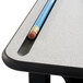 A beige Safco AlphaBetter stand up desk with a pencil on it.