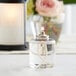 A Leola liquid paraffin fuel candle burning inside a glass container.