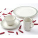 A white bouillon cup with a green speckled rim.