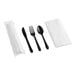 A pre-rolled and individually wrapped set containing a white linen-like napkin and black extra heavy weight plastic cutlery including a knife, fork, and spoon.