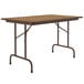 A brown rectangular Correll folding table with metal legs.