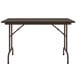 A rectangular Correll walnut folding table with a metal frame and metal legs.