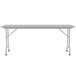 A gray rectangular Correll folding table with a gray frame.