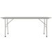 A long rectangular white Correll folding table with a gray metal frame.