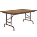 A brown rectangular Correll folding table with metal legs.