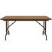 A brown rectangular Correll folding table with black legs.