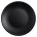 A matte black Tuxton Coupe china plate with a white circle.