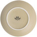 A Tuxton TuxTrendz Zion matte beige coupe plate with a white rim.