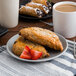 A Tuxton TuxTrendz matte gray coupe china bread and butter plate with a plate of pastries and a cup of coffee.