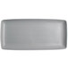 A rectangular Tuxton China tray with a textured gray and white design.