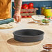A round, straight-sided, hard coat anodized aluminum pan designed for baking cakes or deep dish pizzas.