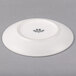 A white Tuxton China bread and butter plate with a black rim.