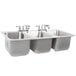 A stainless steel Advance Tabco drop-in sink with three compartments.