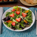A Tuxton Zion matte white china plate with a salad of strawberries and cheese.