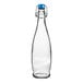 A clear glass Libbey water bottle with a blue wire bail lid.