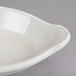 A white Hall China oval rarebit dish with a handle.