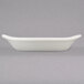 A white rectangular Hall China au gratin dish with a handle.