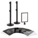 A black Lancaster Table & Seating crowd control stanchion sign board with clear covers.