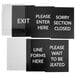 A Lancaster Table & Seating stainless steel stanchion sign frame with clear covers holding black and white signs with white text.