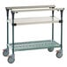 A stainless steel Metro PrepMate Multistation cart with wheels and two shelves.