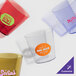 A group of amber Cambro plastic tumblers with a sticker on one of them.