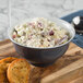 A Schonwald blue-grey porcelain bowl filled with chicken salad on a table