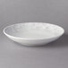 A white bowl with a gray rim on a gray background.