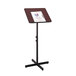 A mahogany and black Safco adjustable speaker stand with a clipboard on it.