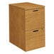 a wooden file cabinet with black handles