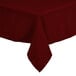 A burgundy rectangular tablecloth with a white hem on a table.