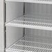 A white Turbo Air merchandiser freezer with shelves.