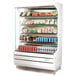 A white Turbo Air refrigerated display case with food and drinks on shelves.