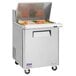 A Turbo Air refrigerated sandwich prep table with a stainless steel top and wheels.