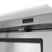 A Turbo Air stainless steel refrigerated sandwich prep table on a counter in a professional kitchen.