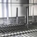 A stainless steel Turbo Air sandwich prep table with a metal rack inside.