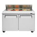 A Turbo Air stainless steel refrigerated prep table with food trays inside.