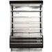 A black Turbo Air refrigerated air curtain merchandiser with shelves.