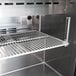 A Turbo Air stainless steel refrigerated sandwich prep table with metal shelves.