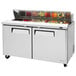 A Turbo Air stainless steel refrigerated sandwich prep table with 2 doors.