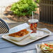 A rectangle EcoChoice paper food tray filled with food on a table.