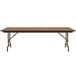 A Correll medium oak rectangular folding table with metal legs.